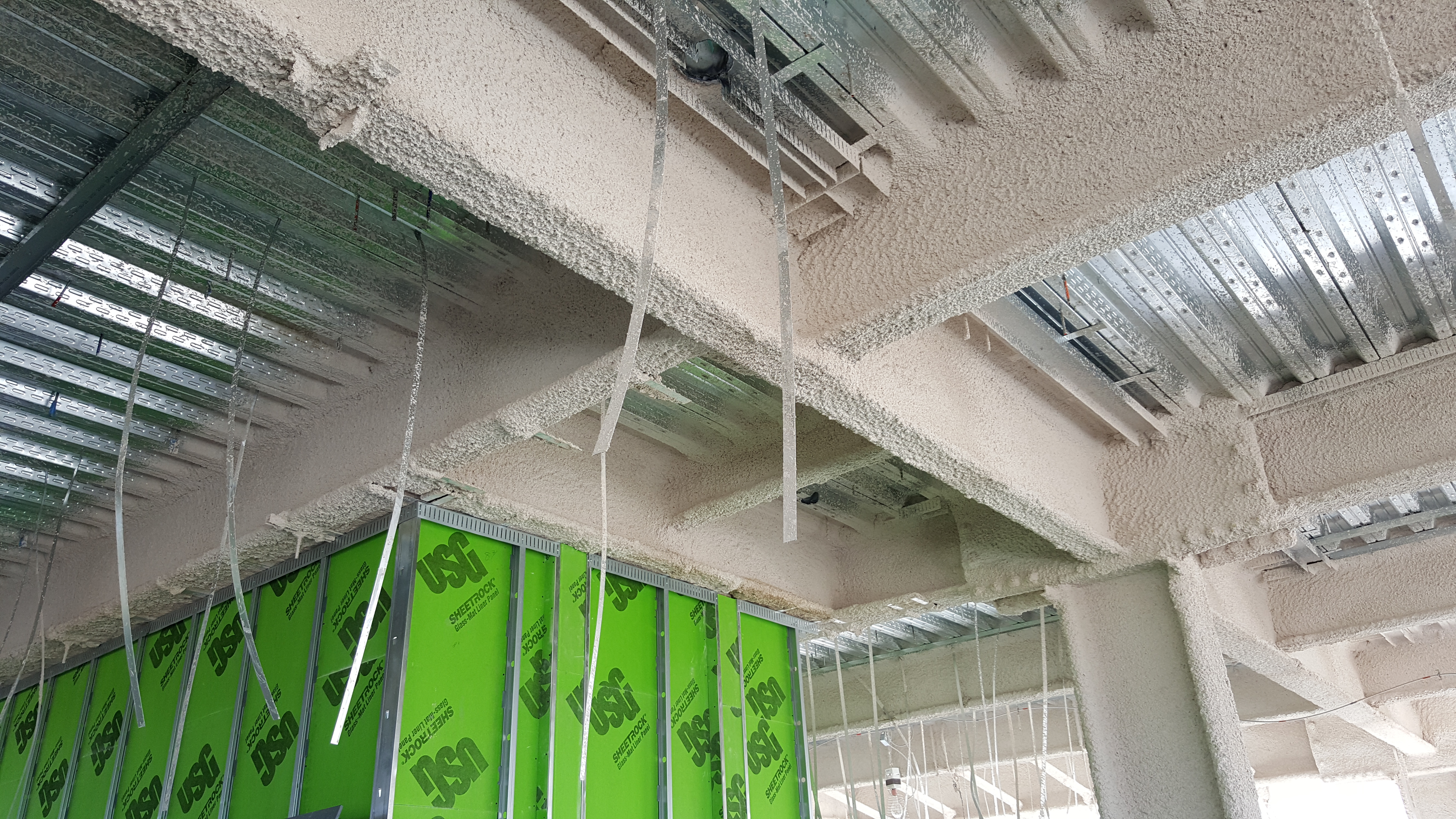 Fireproofed beams with wall sheathing