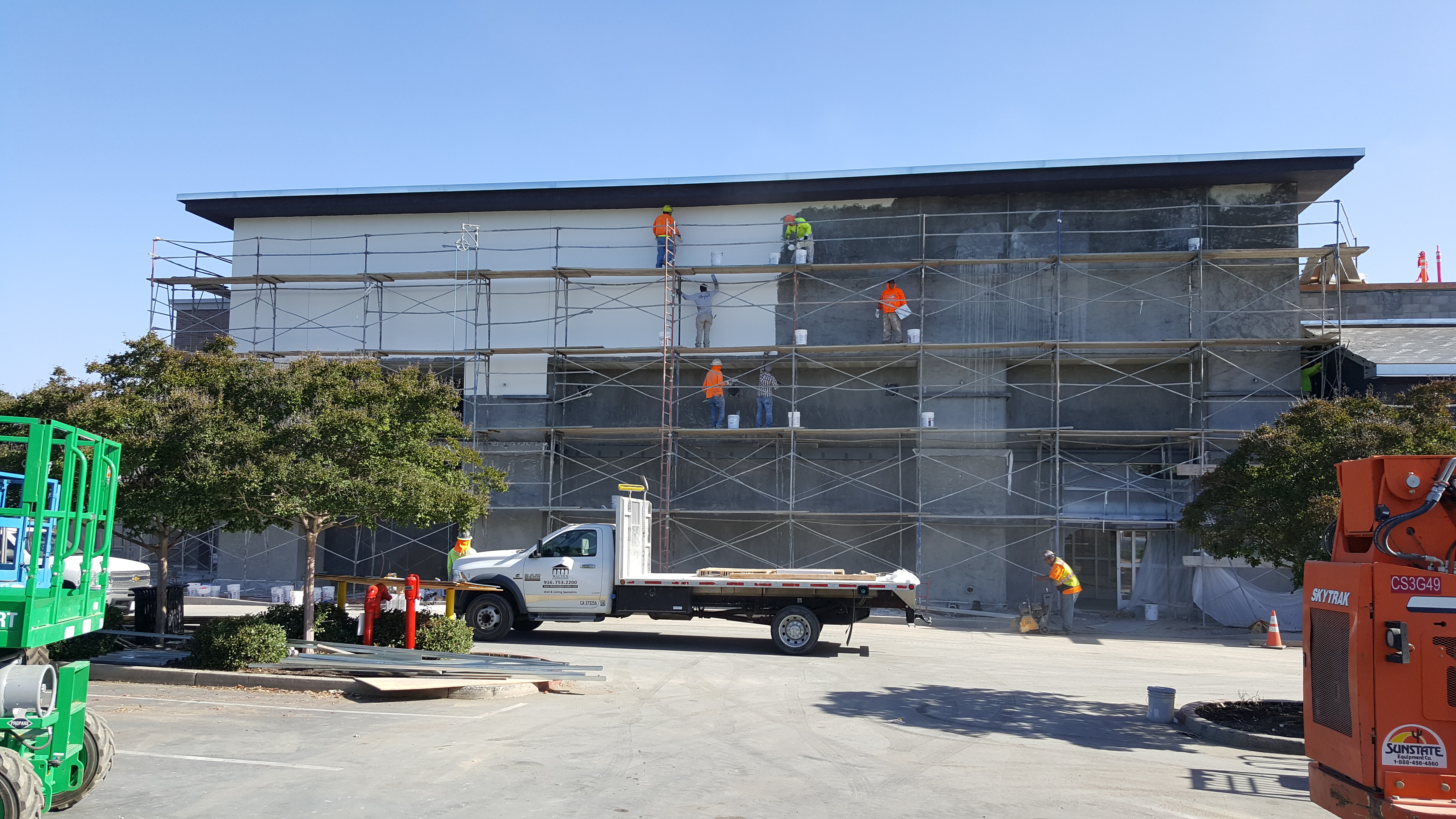 Scaffolded retail stucco facade
