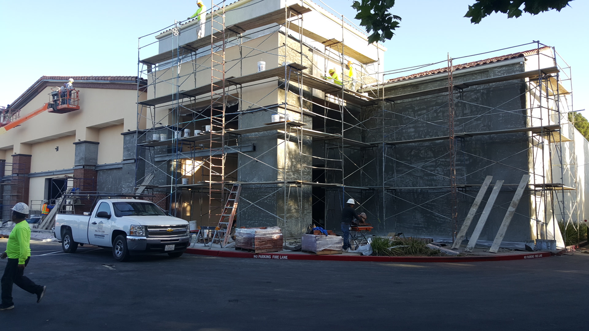 Scaffolded storefront stucco work